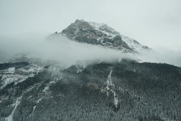 snow covered mountains in cloud in banff