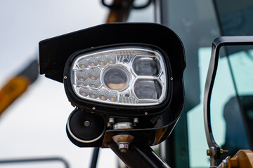 led work light headlamp on heavy construction machinery showing modern industrial illumination...