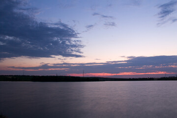 A body of water with a bridge in the background