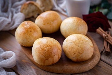 Delicious sweet buns on a wooden table. Small buns for dessert. Close-up