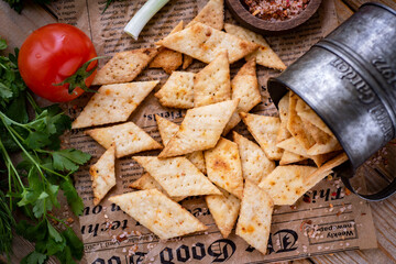 Crispy crackers on the table. Delicious salted cookies in a beautiful vase. Close-up