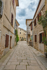 Narrow cobblestone street in historic village Visnjan, Croatia.