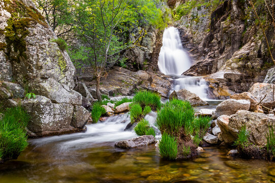 Long exposure of "Cascada del Purgatorio" waterfall near Rascafria, in Madrid, Spain - Powered by Adobe