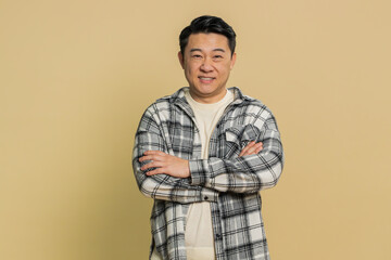 Portrait of happy Asian middle-aged man smiling friendly, glad expression looking dreaming resting,...