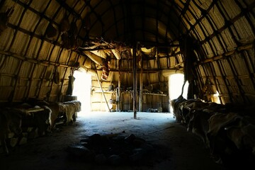 Interior of a traditional Native American tent, or indigenous hut, with an authentic stone fire pit...