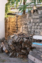 a large old house is made of stone and brick, a pile of stones