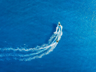 Vacation and leisure. Seascape with motorboat. Aerial view on fast boat on blue sea at sunny day....