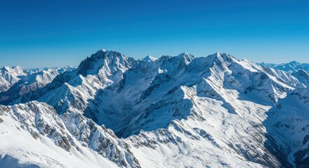 Panoramic vista of snow-capped mountain range under a bright azure sky creating a striking
