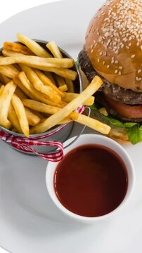 Animation of hamburger and chips over white background