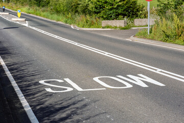 Rural Road with White SLOW and No Overtaking Center line Markings