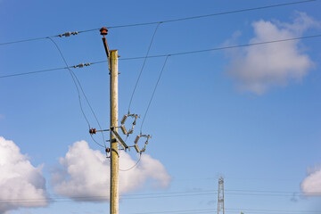 Electricity Utility Pole and Power Lines Against Blue Sky