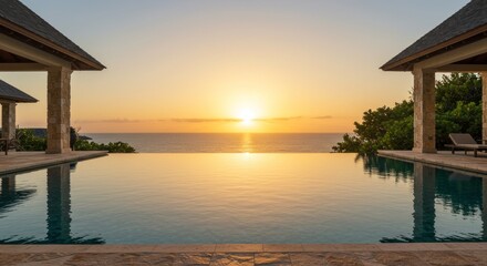 Luxury infinity pool overlooking the ocean at sunset offers serene landscape reflections