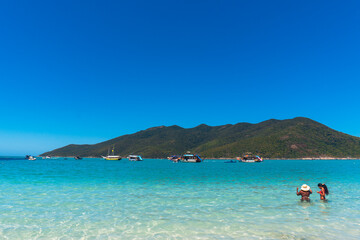 Pontal do Atalaia, Brazil. Swimmers enjoy a sunny day at the beautiful Pontal do Atalaia Beach,...