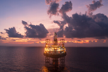 Aerial view of offshore jack up drilling rig during sunset - oil and gas industry