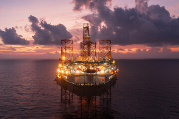 Aerial view of offshore jack up drilling rig during sunset - oil and gas industry