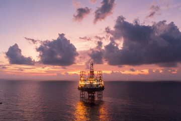 Aerial view of offshore jack up drilling rig during sunset - oil and gas industry