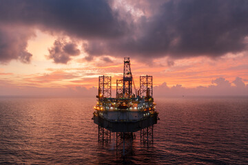 Aerial view of offshore jack up drilling rig during sunset - oil and gas industry