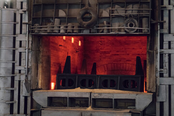 Steel-making gas furnace of metalworking shop lined with brick. Close-up. Blurring thermal haze effect due to high temperature.