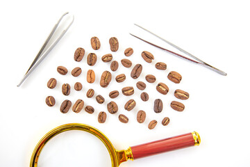 A golden magnifying glass with a red handle lies on a white background, surrounded by scattered roasted coffee beans, creating a unique and artistic composition