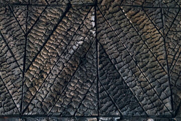 Charred wooden furniture. Decoration surface after fire.