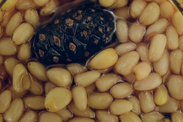 Pine nuts with young cones in in pine syrup. Siberian sweet treat.