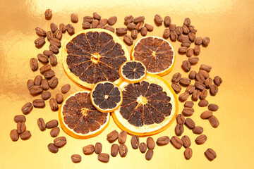 coffee beans and dried orange slices on a shiny golden surface, a striking visual for food and drink photography. coffee aroma and taste citrus descriptors