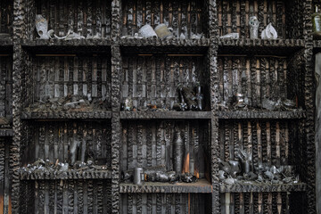 Charred wooden bar shelves. Showcase with drinks after fire.