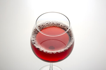 glass with red wine on a light background