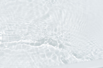 Bluewater waves on the surface ripples blurred. Defocus blurred transparent blue colored clear calm water surface texture with splash and bubbles. Water waves with shining pattern texture background.