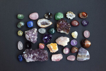 Background of beautiful natural colored semi-precious stones. Purple fluorite, rose quartz and...