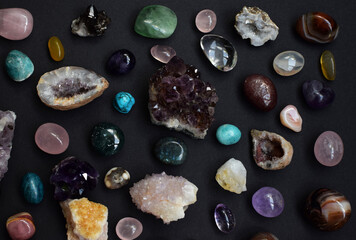 Background of beautiful natural colored semi-precious stones. Purple fluorite, rose quartz and...