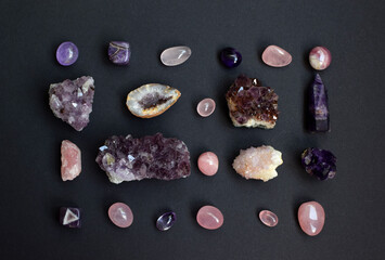 Background of beautiful natural colored semi-precious stones. Purple fluorite, rose quartz and...