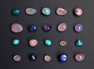 Background of beautiful natural colored semi-precious stones. Purple amethyst, rose quartz,...