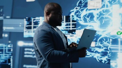 Tech savvy black engineer working with AI brain data visualization, illustrating computer science and automation tools for deep learning. Implementing neural networks systems. Camera B. - Powered by Adobe