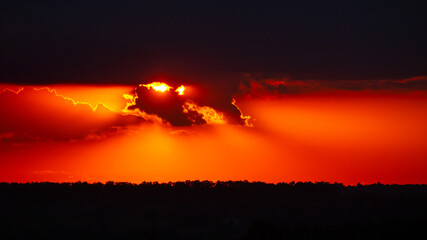 Vibrant sunset sky with golden clouds illuminated by the last rays of sunlight. The warm tones...