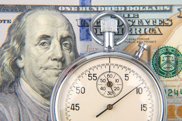 mechanical stopwatch on the background of dollars. Part time accuracy for business. business and...