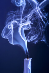Smoke from an extinguished candle on a dark background. The concept of spirituality and the end of...
