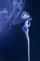 Smoke from an extinguished candle on a dark background. The concept of spirituality and the end of...