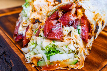 Delicious burrito filled with fresh ingredients served on a wooden platter at a vibrant eatery during lunch