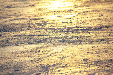 bright traces of ice skating on an ice rink. background and texture. reflection in the sunlight