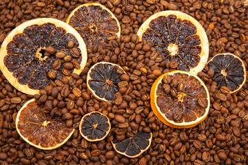 A cozy composition of roasted coffee beans topped with dehydrated orange slices, evoking the scent of a gourmet coffee blend. coffee aroma and taste descriptors