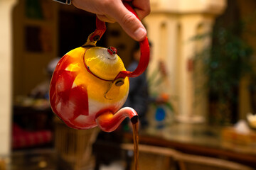Close up of a colorful teapot pouring tea at the Al Koot Heritage Hotel