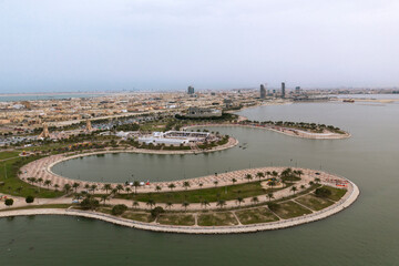 An aerial view from the water of the waterfront of Dammam, with the beautiful pedestrian promenade extending into the Arabian Gulf and the city of Dammam in the background