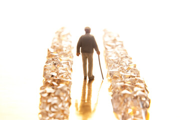 A tiny suited figure walks through a sparkling crystal pathway on a reflective golden base,...