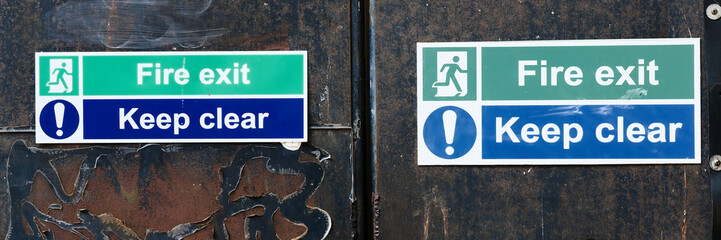 Fire exit keep clear sign on construction building site door
