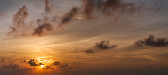 Beautiful sunset sky scenery. Bright colorful orange and yellow clouds on horizon