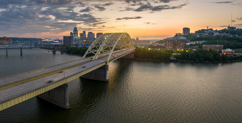 Downtown district of Cincinnati city in Ohio, USA at sunset with driving cars traffic on Daniel...