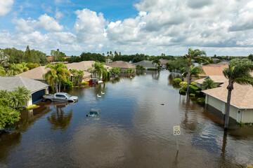 Fototapeta premium Flooded residential area with underwater cars and houses from hurricane rainfall water in Florida suburban community. Aftermath of natural disaster in southern USA