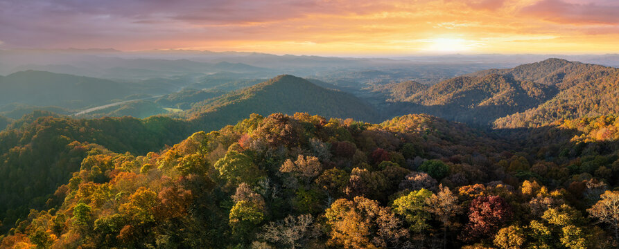 Wooded sunset hills of Appalachian mountains in North Carolina with lush and evergreen forest trees at fall season. Beauty of autumnal nature