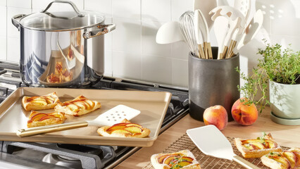 Delicious peach pastries being prepared in a cozy kitchen with modern utensils and fresh ingredients.